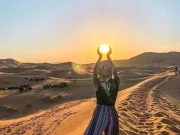 Image capturing the sweeping panorama of the Agafay desert's endless sand dunes, embodying the tranquil and stark beauty encountered en route to an unforgettable day trip.