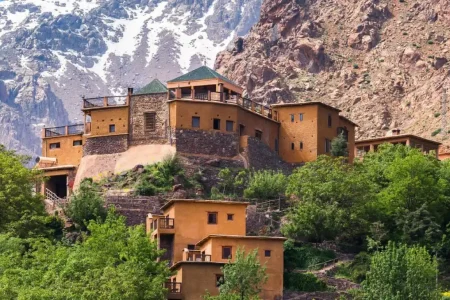 Image capturing the essence of the ultimate destination for an Imlil Day Trip: a picturesque view of lush valleys and rugged peaks of the High Atlas Mountains