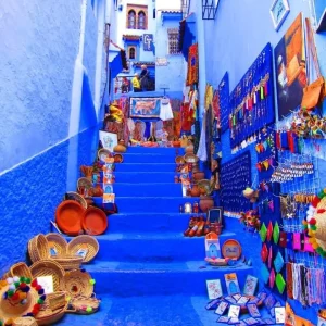 Comfortable shuttle van on a scenic road en route to the vibrant blue city of transfer Chefchaouen, Morocco.