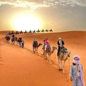 Comfortable 4x4 vehicle traversing the rugged desert landscape en route to the captivating dunes of Transfer Merzoga.