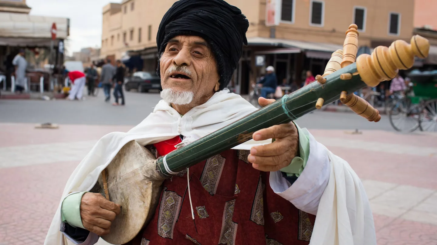 Visit to Marrakech And Aspects 1 Bustling Jemaa el-Fnaa square in the historic Medina of visit to Marrakech, Morocco, with traditional market stalls, street performers, and iconic architecture.